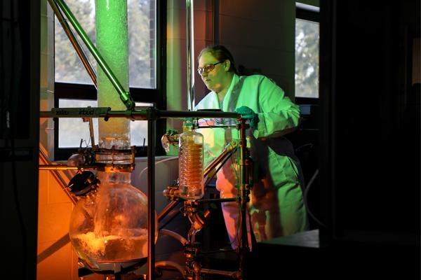 Student looking at a giant glass beaker